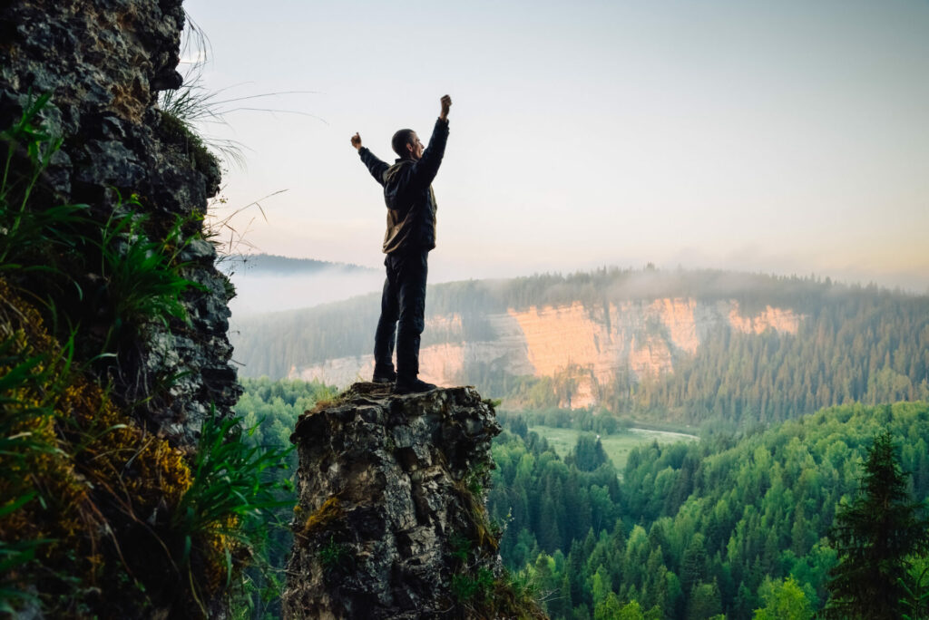 Man in nature with arms up