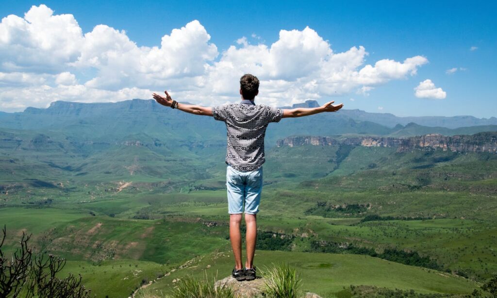 Man Wearing Grey Shirt Standing on Elevated Surface